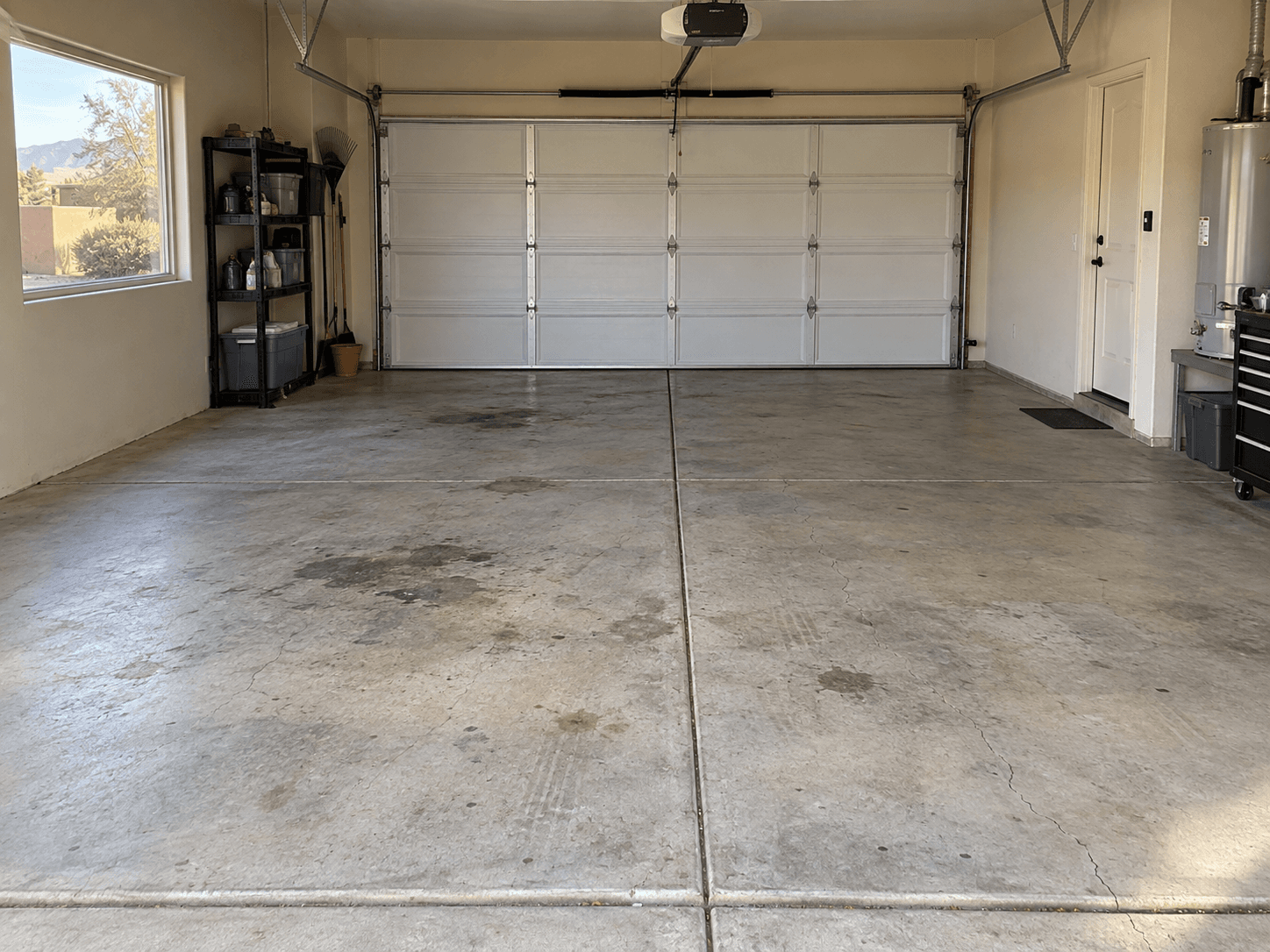Uncoated worn concrete garage floor before coating